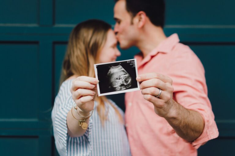 A happy couple with a supportive birth partner